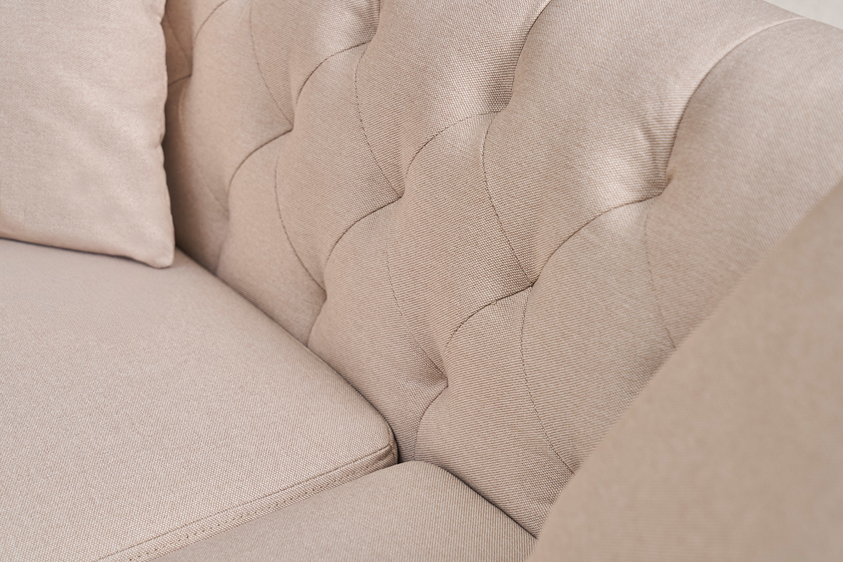 Primo piano sullo schienale trapuntato del divano a 2 posti in tessuto beige MONTAIGNE.