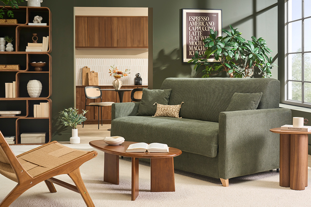Divano letto a 3 posti in tessuto ciniglia verde scuro in un soggiorno moderno con un tavolino basso in legno.