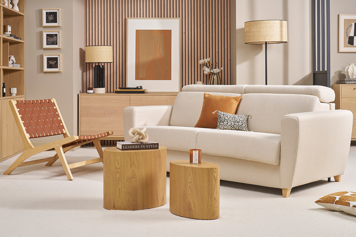 Divano letto a 3 posti in tessuto beige e legno chiaro in un salotto moderno.