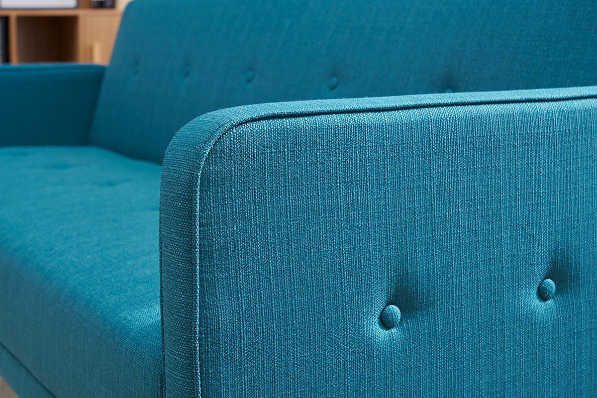 Dettaglio del braccio e dello schienale del divano letto blu in tessuto, vista ravvicinata.