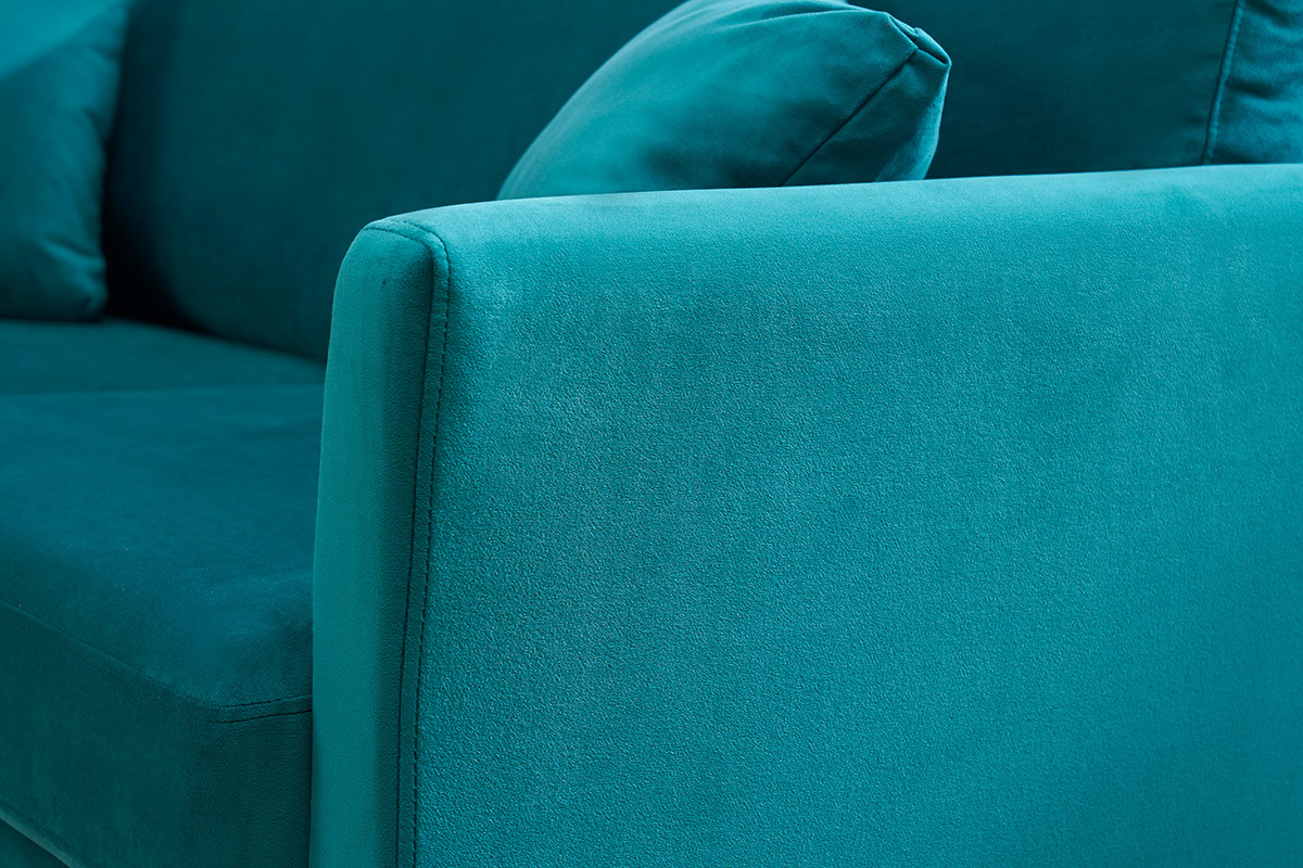 Bracciolo di divano in velluto blu petrolio con cuscino.