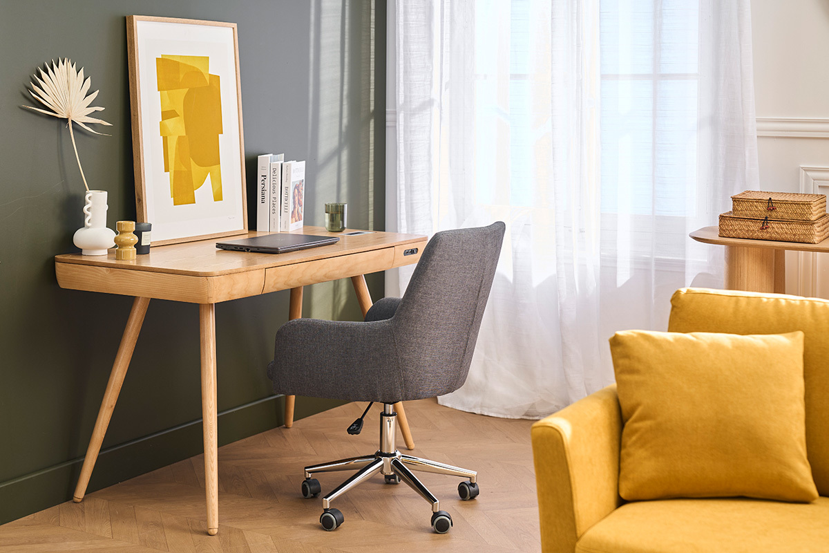 Sedia da ufficio SHANA in tessuto grigio antracite con ruote, vista posteriore, davanti a una scrivania in legno.