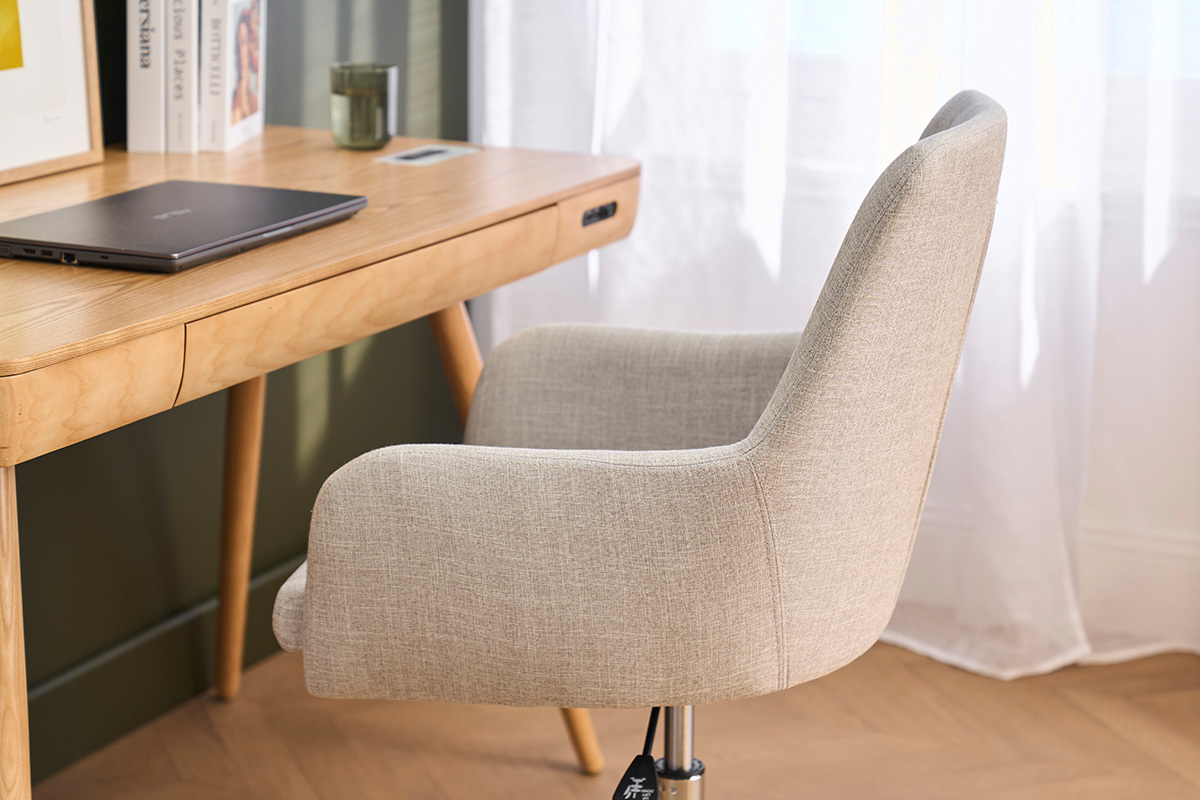 Sedia da ufficio SHANA in tessuto grigio chiaro vista da dietro vicino a una scrivania in legno.