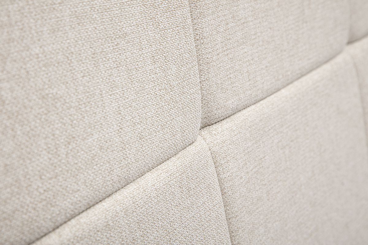 Primo piano sul tessuto beige crema trapuntato della testiera CLOVIS.